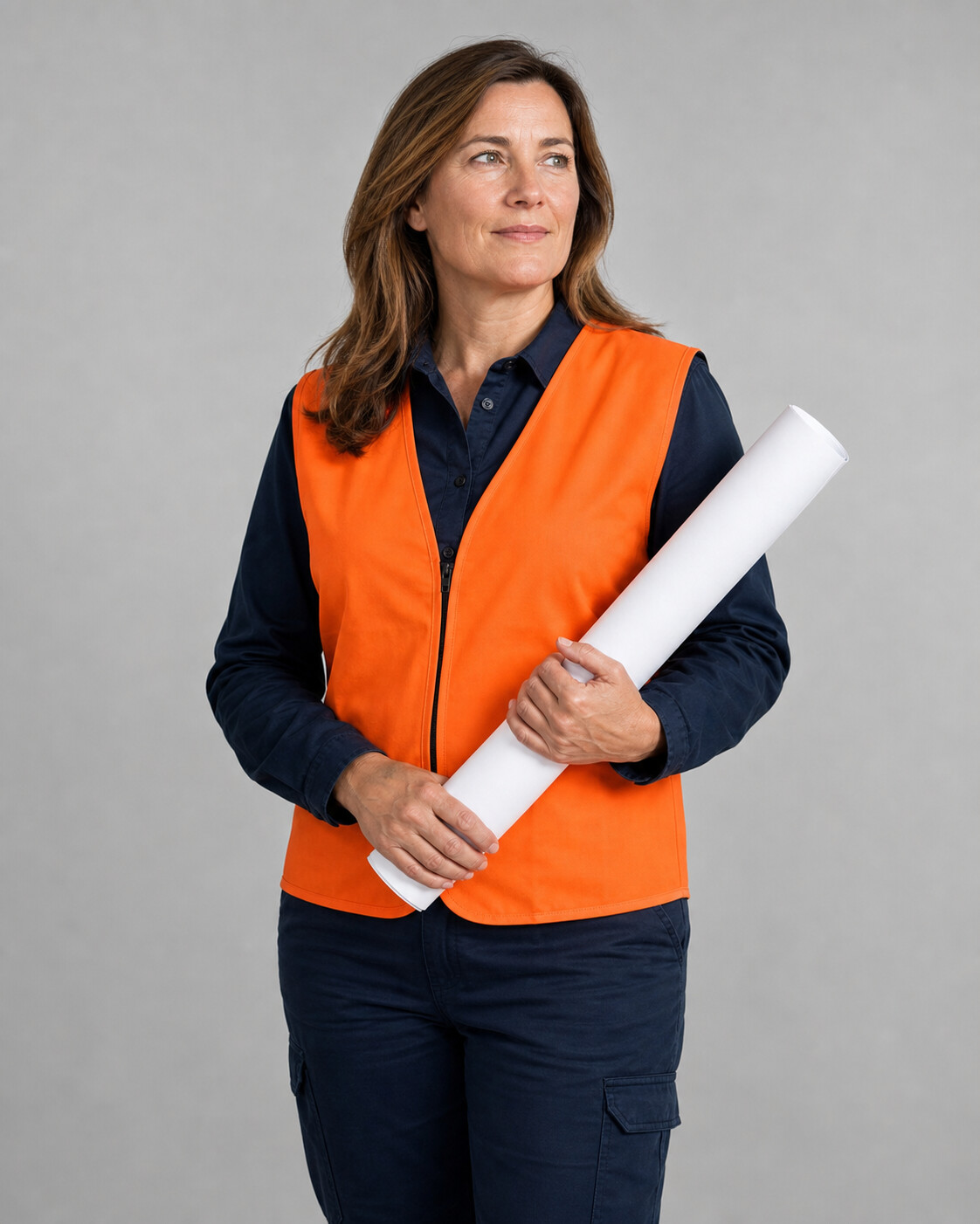 an asphalt paving professional beside a newly paved asphalt surface